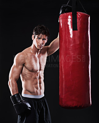 Buy stock photo Boxing, man and portrait in studio with punching bag for workout, exercise or fight competition with dark background. Gloves, boxer and serious male athlete for confidence, martial arts and fitness