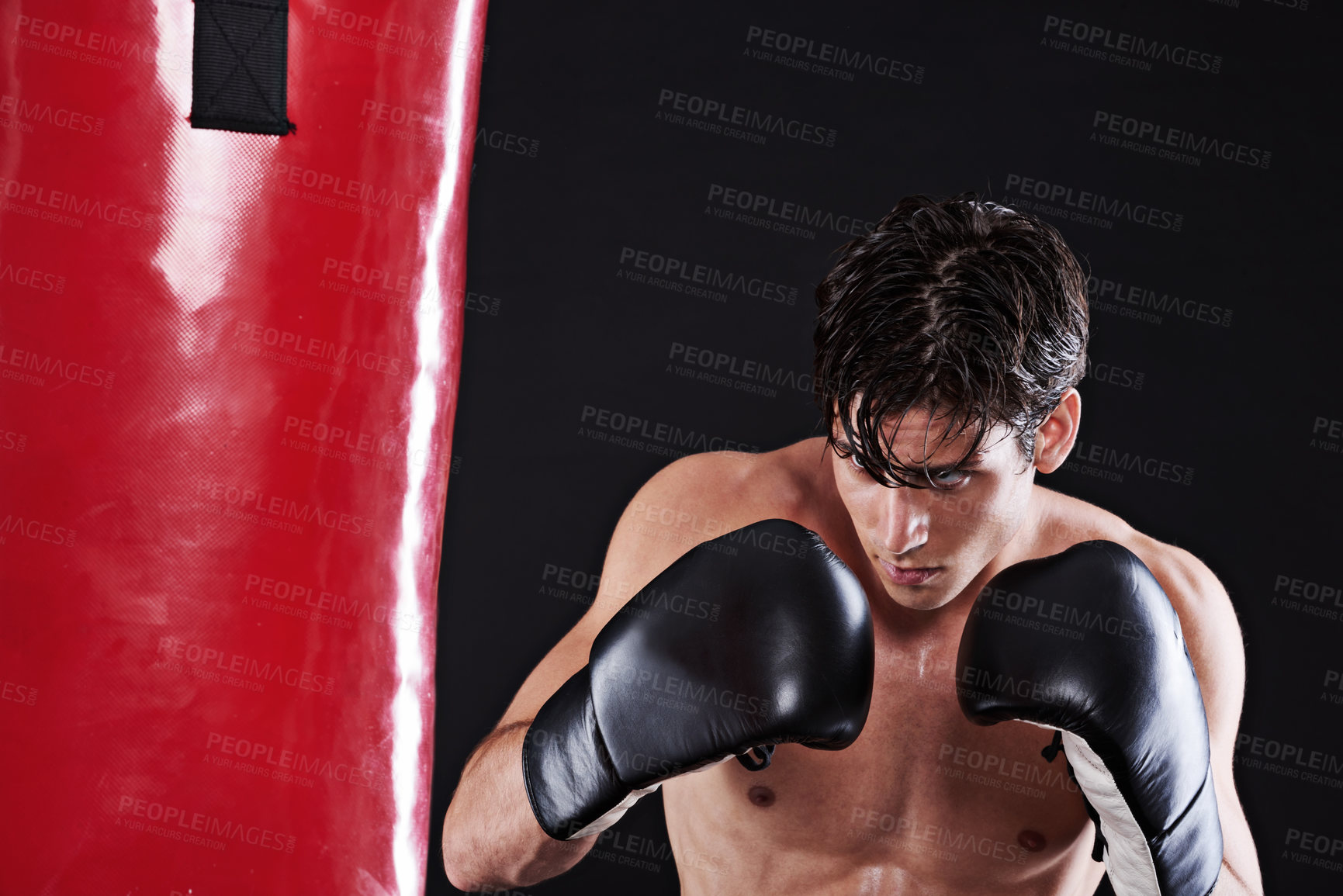 Buy stock photo Man, boxing gloves and bag for fitness practice or cardio exercise for health, fighter or black background. Male person, punch and martial arts training in studio for gym self defence, fist or mockup