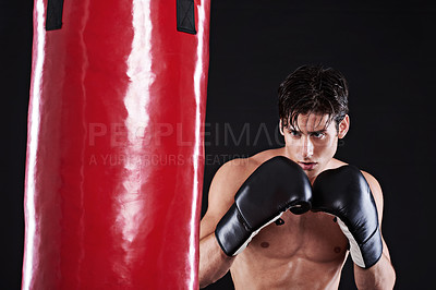 Buy stock photo Fitness, boxing or man with punching bag in studio for exercise, challenge or competition training. Power, muscle or champion boxer at workout with confidence, martial arts fight and black background