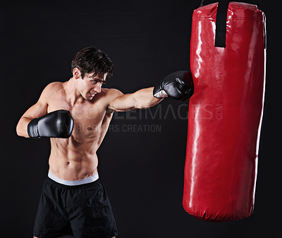 Buy stock photo Man, athlete and punch on boxing bag with gloves for exercise workout, martial arts or black background. Male person, fist and fitness health as gym professional for fighter, mockup space or studio