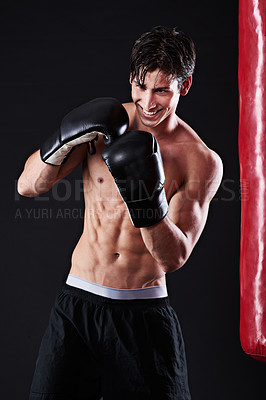 Buy stock photo Man, boxing gloves and smile at bag for martial arts practice in studio for fitness, exercise or black background. Male person, athlete and gym fighter or training performance on mockup, sport or abs