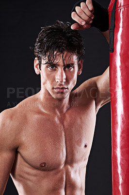 Buy stock photo Portrait, muscular and man with training, boxing and fitness on a dark studio background. Face, person and model with challenge and endurance with progress and wellness with punching bag and healthy
