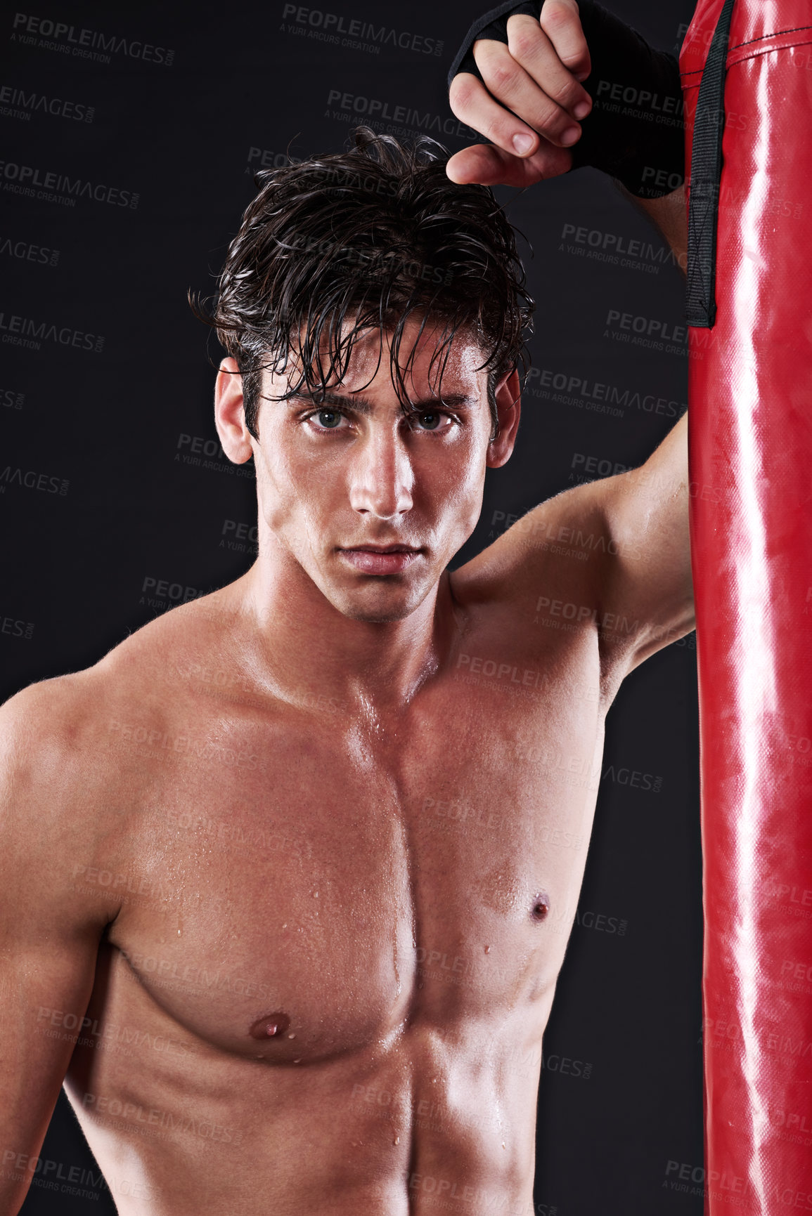 Buy stock photo Portrait, muscular and man with training, boxing and fitness on a dark studio background. Face, person and model with challenge and endurance with progress and wellness with punching bag and healthy