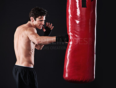 Buy stock photo Man, punching bag and boxing with fitness, training and fighter with gloves, cardio and wellness with endurance. Boxer, practice or athlete with exercise or workout with challenge on black background
