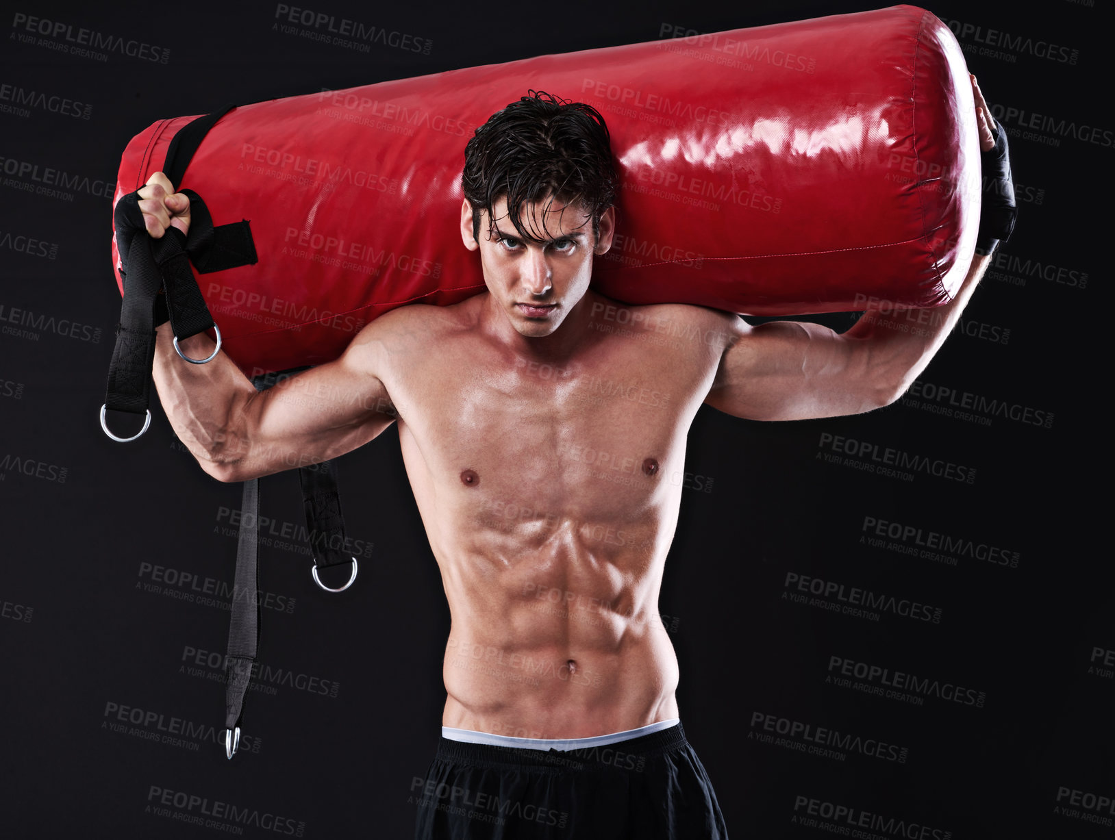 Buy stock photo Portrait, punching bag and man with training, boxing and fitness on a dark studio background. Face, person and model with challenge and endurance with progress and wellness with health and strength