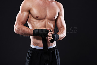 Buy stock photo Boxer, hands and man with wrapping for martial arts on black background in studio with preparation. Tape, fist and ready to start training body for mma, boxing closeup or gym with fitness mockup