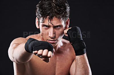 Buy stock photo Boxing, portrait and man punching in studio for exercise, challenge or competition training for gym. Power, muscle or serious champion boxer at mma workout with confidence, fight and black background