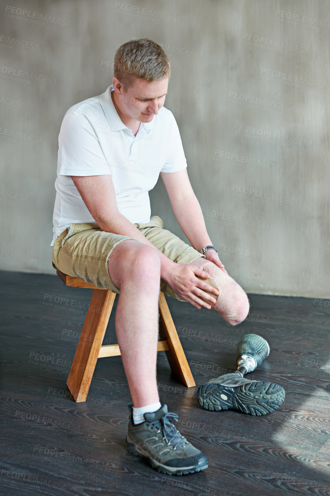 Buy stock photo Dressing, amputee and prosthetic leg and man in gym sitting, residual limb for assemble. Workout, physiotherapy or fitness for wellness or male person with disability , exercise and rehabilitation