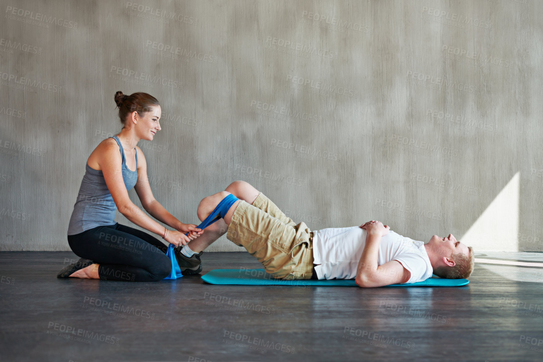 Buy stock photo Shot of a female physiotherapist having a session with a young male amputee