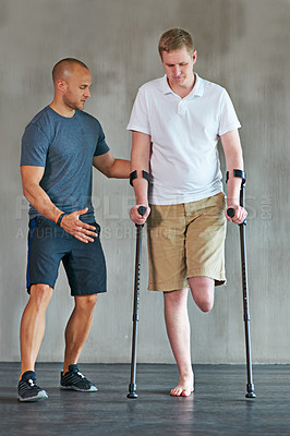 Buy stock photo People, physiotherapy and man with disability for fitness, support and wellness or muscle health in crutches. Physical therapy, physiotherapist and amputee for leg exercise and helping with balance