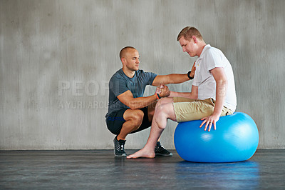 Buy stock photo Physical therapy, gym and exercise ball with a man with a disability and physio consultation for rehabilitation. Physiotherapy, help and healthcare professional with helping and wellness for mobility
