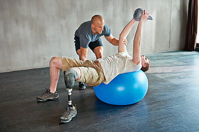 Buy stock photo Patient with disability, physiotherapist and help with kettlebell for exercise at gym for recovery, strength and healthcare rehabilitation. Physiotherapy, amputee or man for consultation with ball