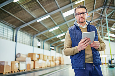 Buy stock photo Portrait of a man with a digital tablet working in a distribution warehouse