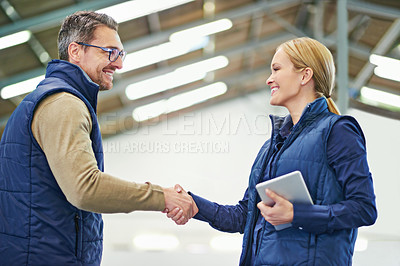 Buy stock photo Warehouse, man and woman shaking hands, tablet and happiness for agreement or deal in storage. Business, client and supplier with smile, male person and girl together in meeting and partnership