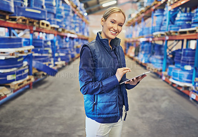 Buy stock photo Portrait of a woman using a digital tablet in a large warehouse
