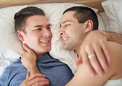 Buy stock photo Happy, men and top view of gay couple in bed at home to relax, embrace and bonding together in the morning. Lgbtq, above and smile of people in bedroom for love, connection and healthy relationship