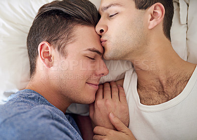 Buy stock photo Shot of a young gay couple relaxing in bed