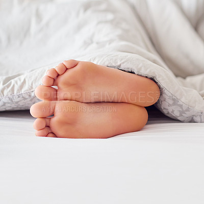 Buy stock photo Feet, person and soles in bed with blanket for sleeping, comfort and warmth in the morning. Foot, toes and heels with duvet cover in bedroom on mattress for relax, tired and cozy in house on weekend