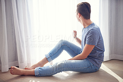 Buy stock photo Window, thinking and man on the floor, home and relaxing with weekend break and morning in a living room. Person, apartment and guy with sunshine and curtains with vacation and light with holiday