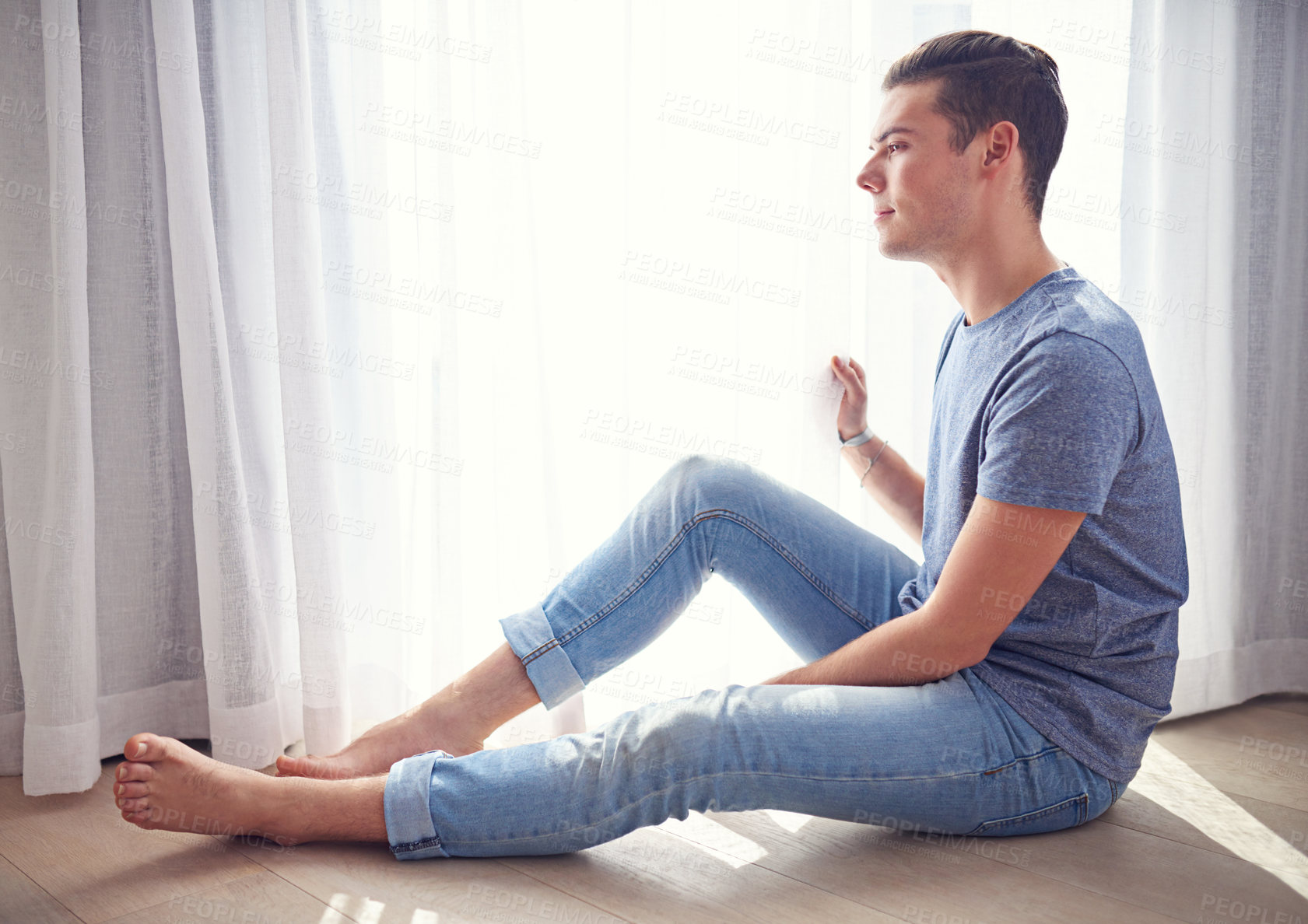 Buy stock photo Window, thinking and man on the floor, apartment and relaxing with weekend break and person in a living room. Summer, home or guy with sunshine and curtains with vacation, peace or light with holiday