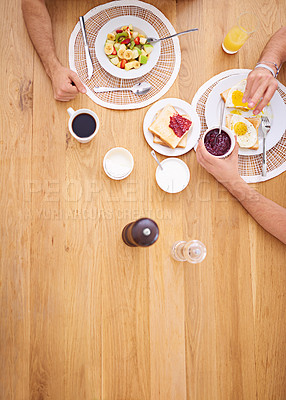 Buy stock photo High angle shot of two people eating breakfast together