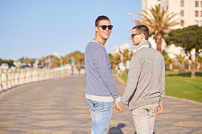 Buy stock photo Gay couple, smile and walk outdoor for trip and travel on vacation for rest and break in summer. Young men, happiness and together in nature for relationship and recreation for joy and love