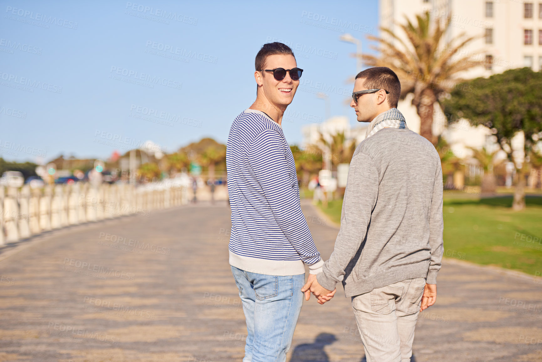 Buy stock photo Gay couple, smile and walk outdoor for trip and travel on vacation for rest and break in summer. Young men, happiness and together in nature for relationship and recreation for joy and love