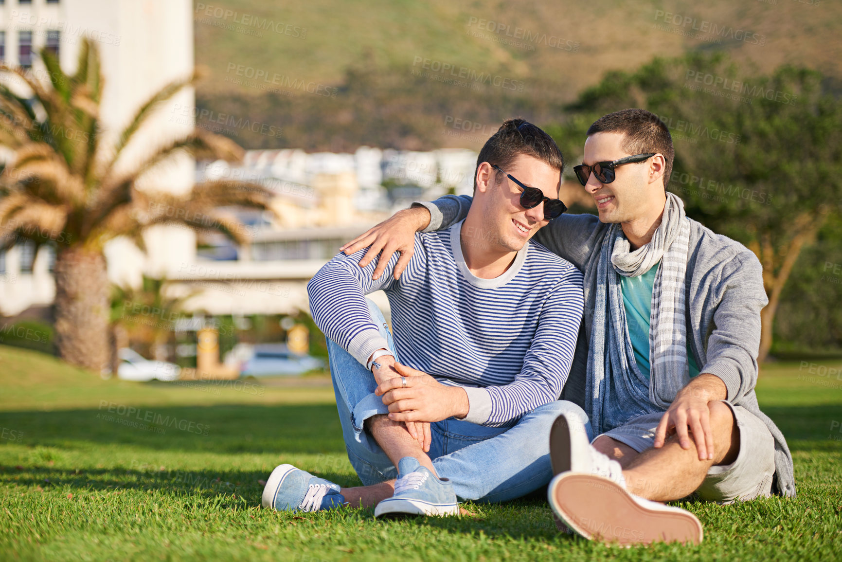 Buy stock photo Shot of a young gay couple enjoying their day together outside