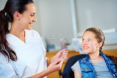 Buy stock photo Woman, dentist and child with floss, girl and smile in a modern office and wellness with care. Trust, support and oral health with string or patient with dental hygiene and cheerful with professional