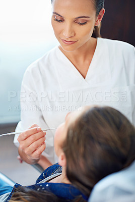 Buy stock photo Dental, child and tool at dentist for healthcare with consultation, mouth inspection or cavity check for oral health. Orthodontics, kid patient or woman for teeth cleaning, gingivitis or medical care