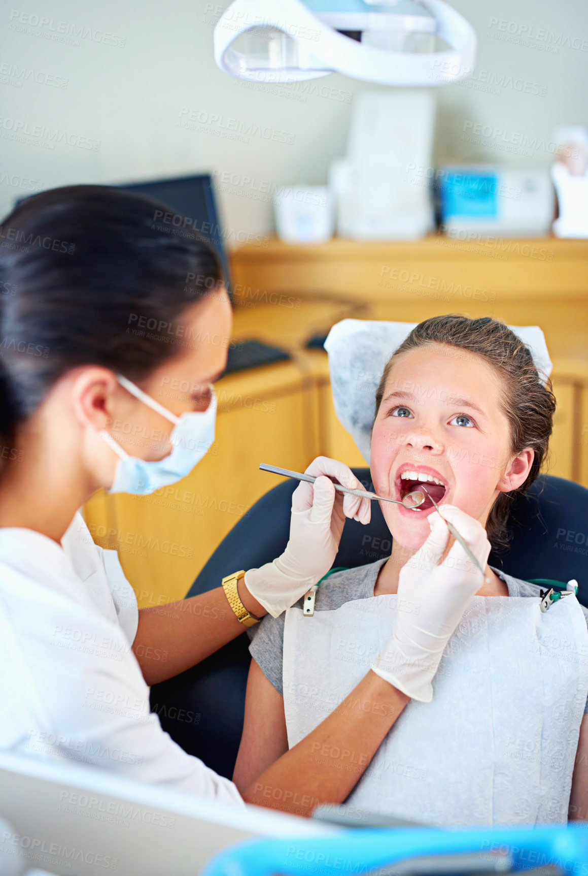 Buy stock photo Girl, child and woman at dentist for healthcare with dental tool, consultation and mouth inspection for oral health. Orthodontics, kid patient or gloves for teeth cleaning, gingivitis or medical care