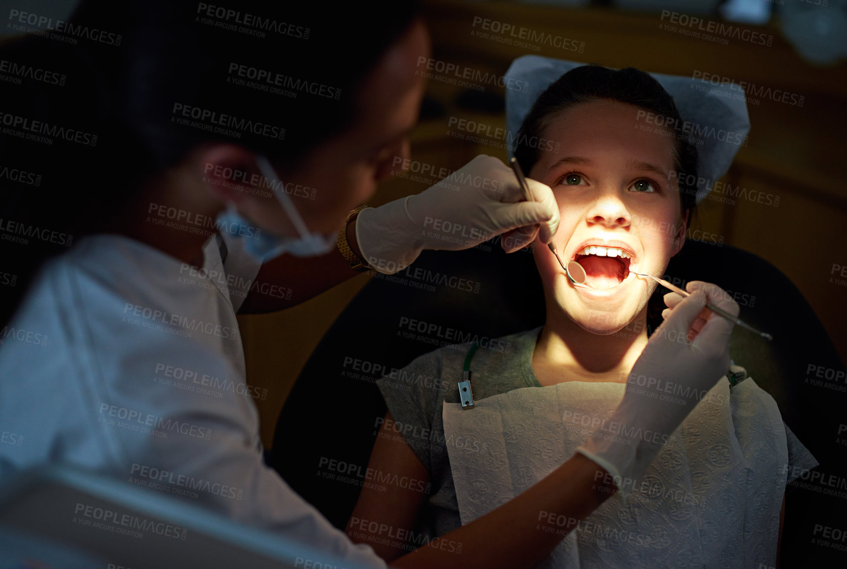 Buy stock photo Dental, mirror or girl with dentist for mouth exam, tooth cavity or gum disease, bacteria or search. Oral care, wellness or doctor with light, equipment or tool for pediatric dentistry or cleaning