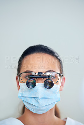 Buy stock photo Portrait of a young female dentist wearing magnifying glasses