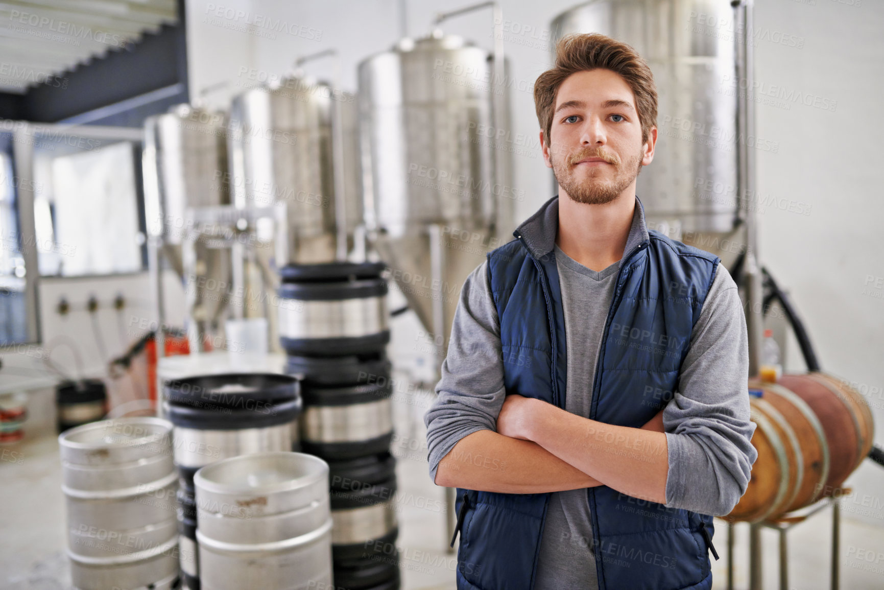 Buy stock photo Brewery, man and portrait with arms crossed in factory with confidence, pride and container machine for manufacturing. Industrial, worker and smile in distillery with tank for brewing in warehouse