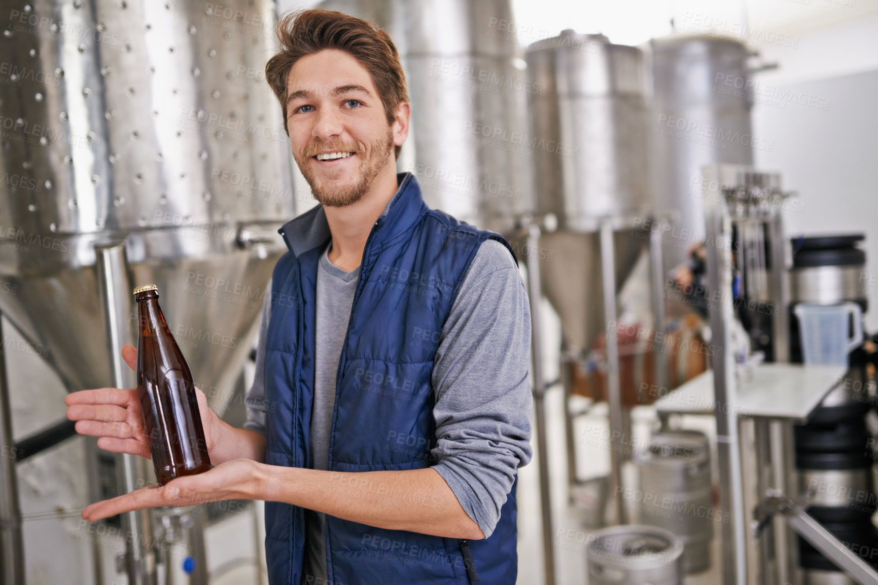 Buy stock photo Brewery, man and bottle with portrait in factory with confidence, craft beer or tank machine for manufacturing. Industrial, worker or smile in career with production line for brewing in warehouse