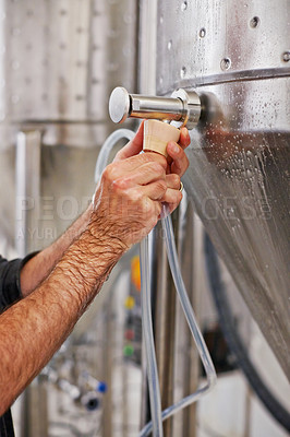 Buy stock photo Beer, production and hand with steel in factory for winery, alcohol and drink manufacturing or distillery. Person working on container or fermentation vessel in closeup for micro brewery and industry