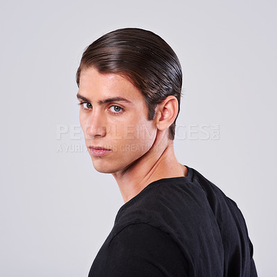 Buy stock photo Handsome man, portrait and fashion with hairstyle, tshirt or hygiene on a gray studio background. Face of attractive and young male person or model with cool hairdo or salon treatment on mockup space