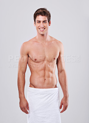 Buy stock photo Towel, happy and portrait of man on a white background for wellness, hygiene and cleaning for health. Skincare, bathroom and isolated person with muscle for shower, self care and washing in studio