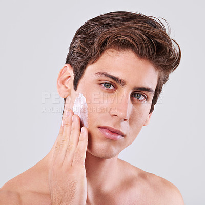 Buy stock photo Man, portrait and skincare with facial cream, lotion or grooming for hygiene on white studio background. Closeup, male person or young model with face creme, sunscreen or moisturizer on mockup space
