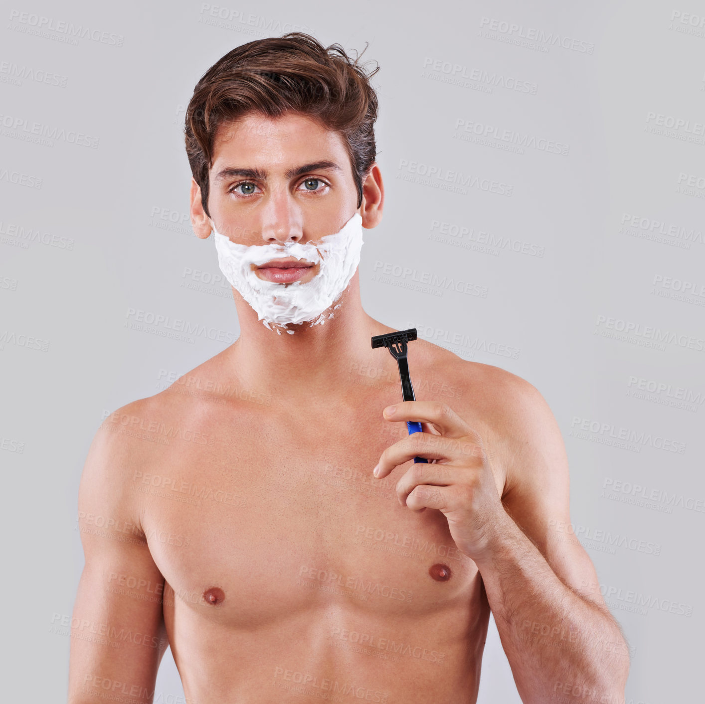 Buy stock photo Studio shot of a handsome bare chested young man shaving