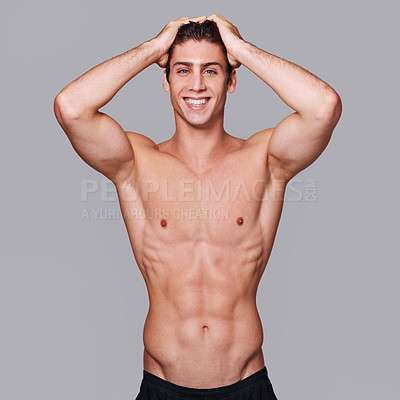 Buy stock photo Studio shot of a handsome bare chested young man grooming