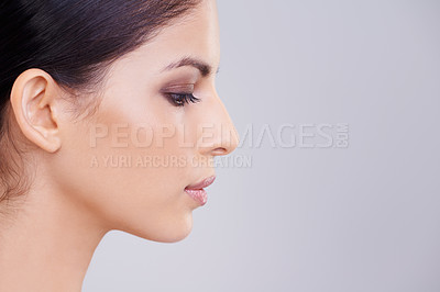 Buy stock photo Studio shot of a beautiful brunette woman against a gray background