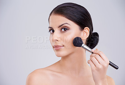 Buy stock photo Woman, portrait and makeup application or brush in studio for beauty blush, cosmetics or grey background. Male person, face and treatment transformation for makeover wellness, mockup space or routine