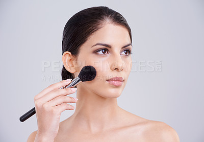 Buy stock photo Woman, makeup and application brush in studio for beauty blush, cosmetics or grey background. Female person, facial contour and treatment transformation for makeover wellness, mockup space or routine