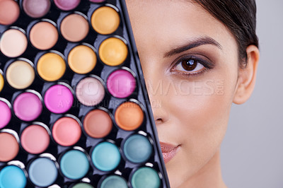 Buy stock photo Eyeshadow, makeup palette and portrait of woman in studio for cosmetics, powder and foundation on gray background. Closeup, beauty and female model with cosmetology product, facial glow and skincare