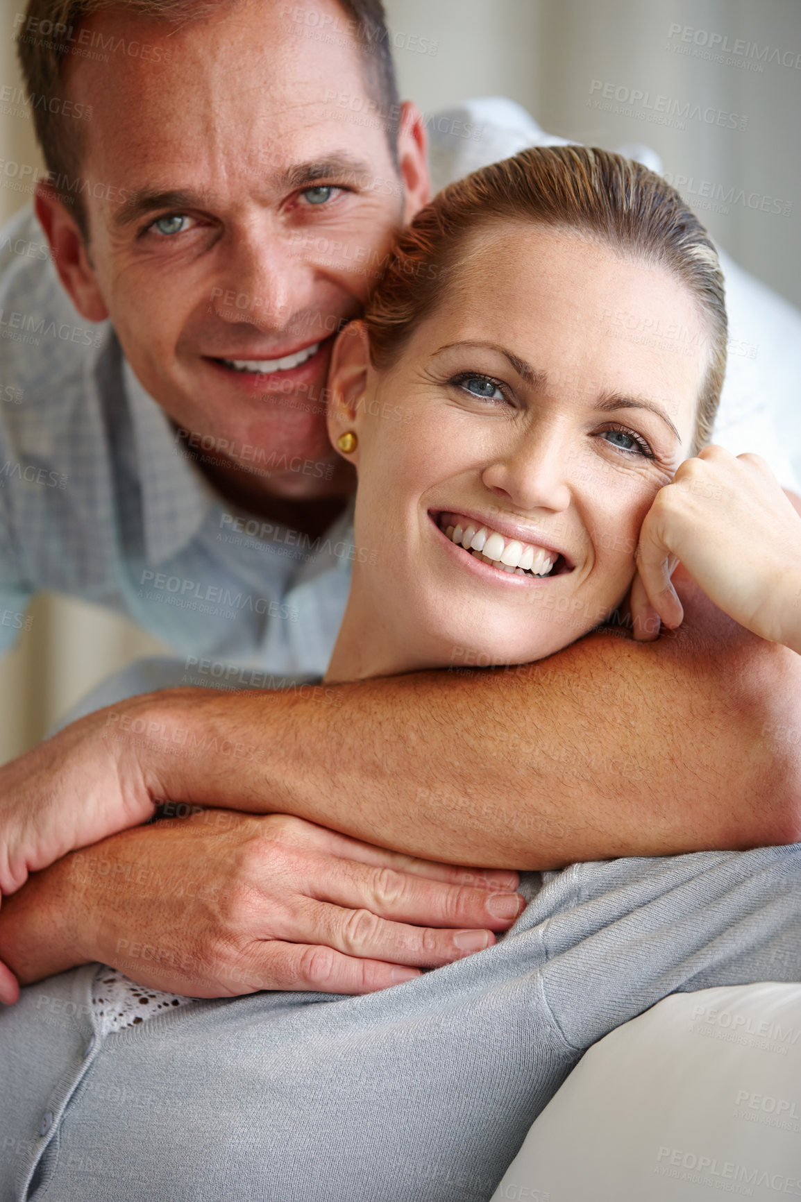 Buy stock photo A close-up of an affectionate couple holding each other indoors