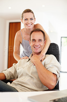 Buy stock photo Smile, portrait and couple in hug on chair, love and proud of marriage milestone in home. Happy, embrace and people for relationship achievement, romance and bonding in apartment for enjoyment