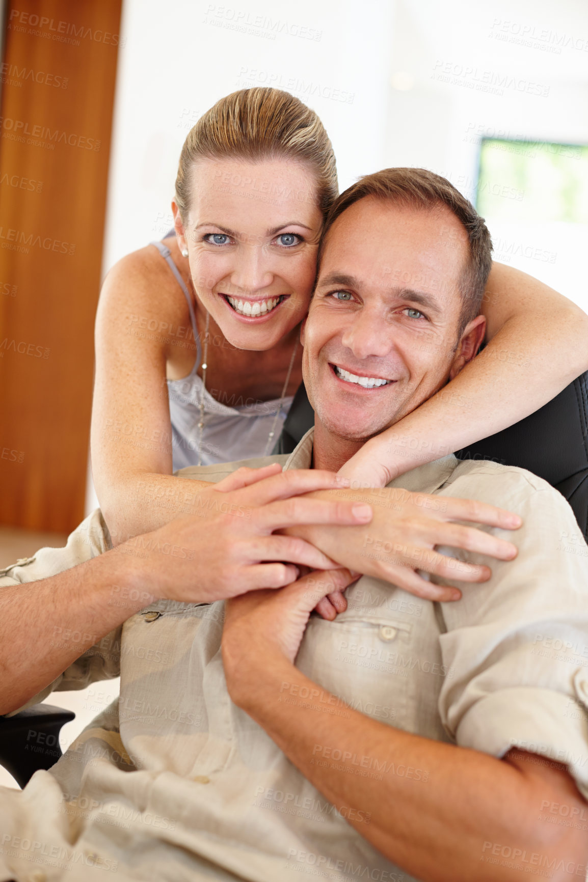 Buy stock photo Smile, portrait and couple in embrace for marriage, love and proud of relationship milestone in home. Happy, hugging and people for support or care, romance and bonding in apartment for enjoyment