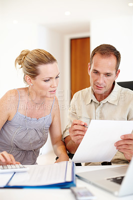 Buy stock photo Couple, documents and financial bills for planning, taxes and reading report, budget or letter of mortgage payment. Man and woman with paperwork, spreadsheet and application for loan with calculator