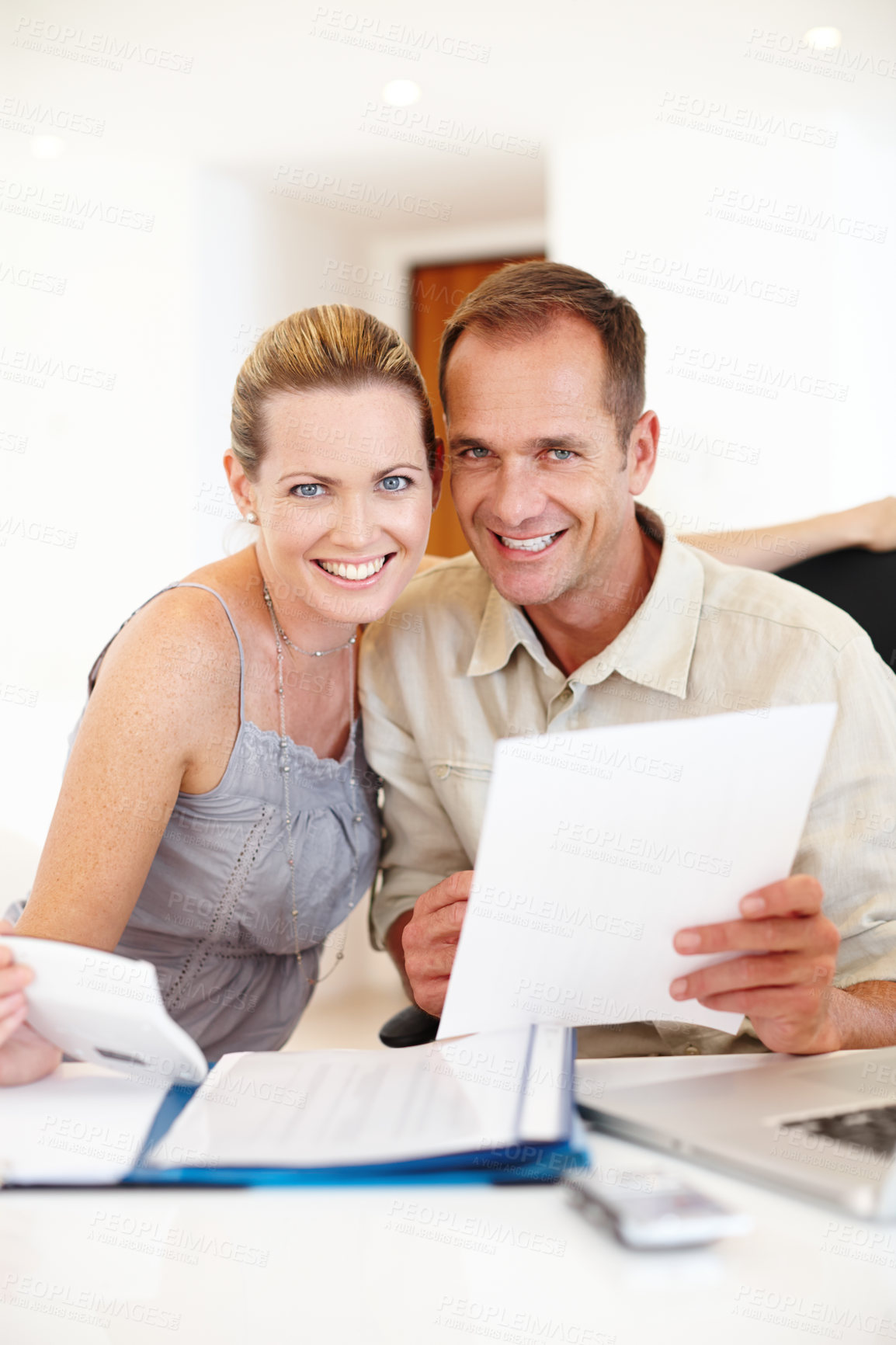 Buy stock photo Couple, home and paperwork with documents in portrait for calculating house finances, budget, taxes and mortgage at table. Happy, people and holding savings account bills for growth of property plan